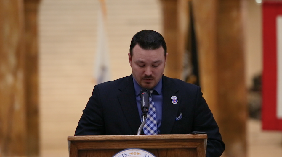 A Massachusetts veteran giving a speech at a podium.